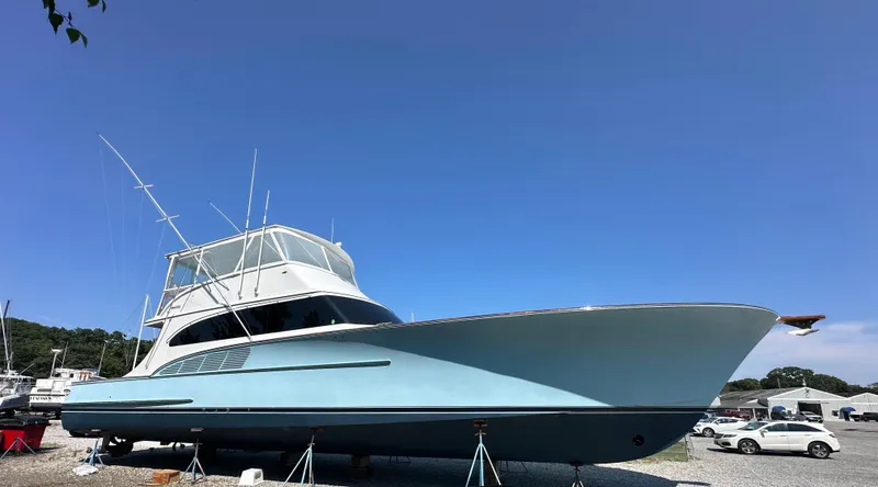 Slide: The Image of Custom Carolina 66 yacht, 2005 model, displayed on land under a clear blue sky. - 47