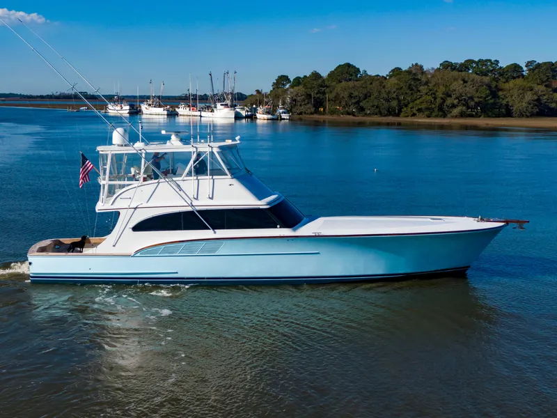 Slide: The Image of Custom Carolina 66 yacht, 2005 model, cruising on calm waters with a clear blue sky. - 7