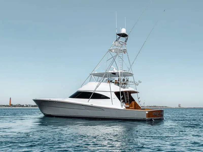 Slide: The Image of 2023 Viking 72 Convertible yacht on calm water, showcasing sleek design and luxury features. - 11
