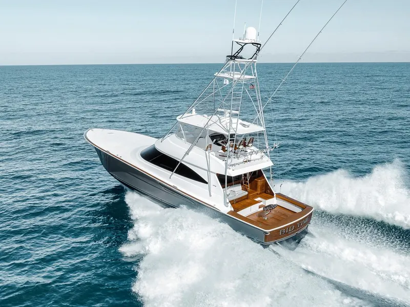 Slide: The Image of 2023 Viking 72 Convertible yacht cruising on open sea. - 12