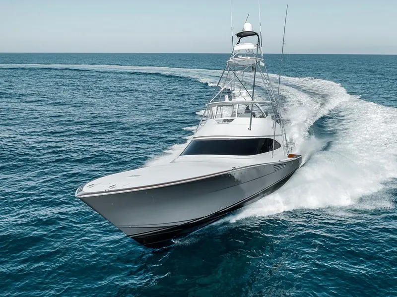 Slide: The Image of 2023 Viking 72 Convertible yacht cruising swiftly on open ocean waters. - 13