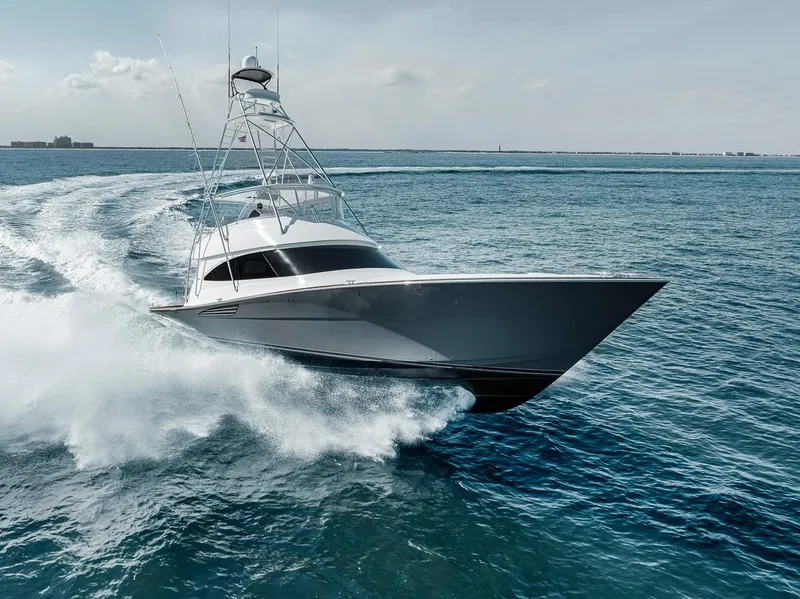 Slide: The Image of 2023 Viking 72 Convertible yacht cruising swiftly on open ocean waters. - 14