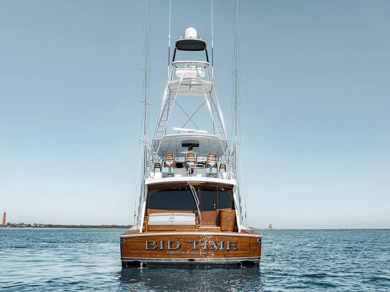 Slide: The Image of 2023 Viking 72 Convertible yacht on calm sea, rear view. - 16