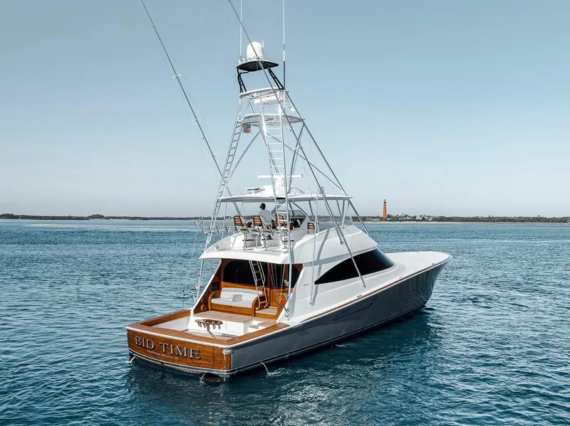 Slide: The Image of 2023 Viking 72 Convertible yacht on calm blue waters, showcasing sleek design and luxury features. - 17