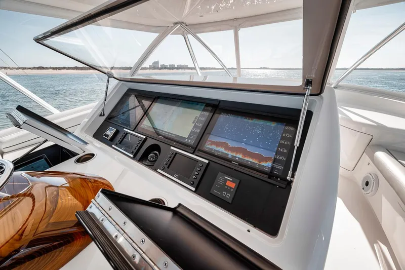 Slide: The Image of 2023 Viking 72 Convertible yacht dashboard with advanced navigation displays. - 2