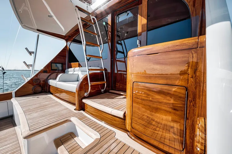 Slide: The Image of Luxurious 2023 Viking 72 Convertible yacht interior with polished wood and elegant seating. - 21