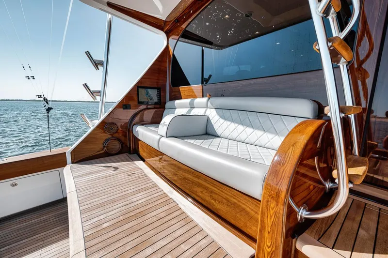 Slide: The Image of Luxurious seating area on 2023 Viking 72 Convertible yacht with elegant wood and leather finishes. - 23