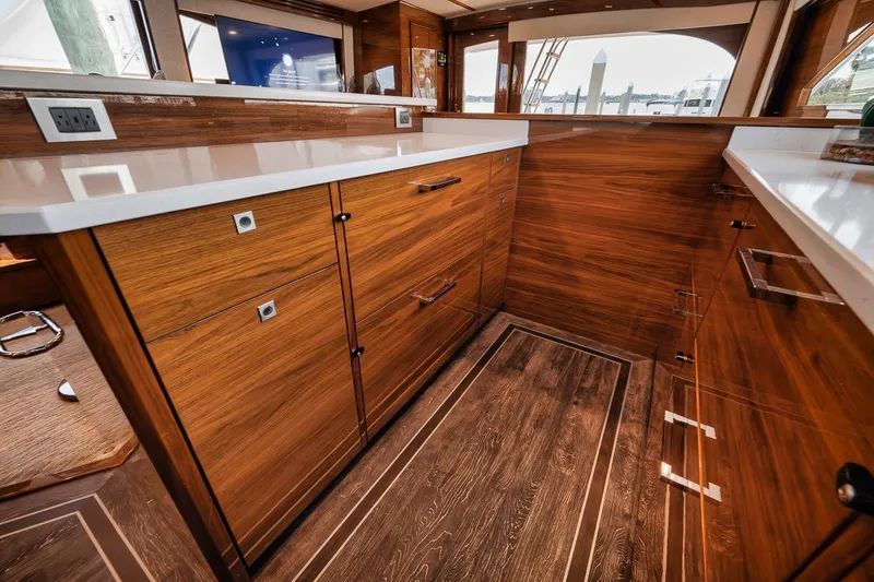 Slide: The Image of Luxurious interior of 2023 Viking 72 Convertible yacht with elegant wood cabinetry. - 32