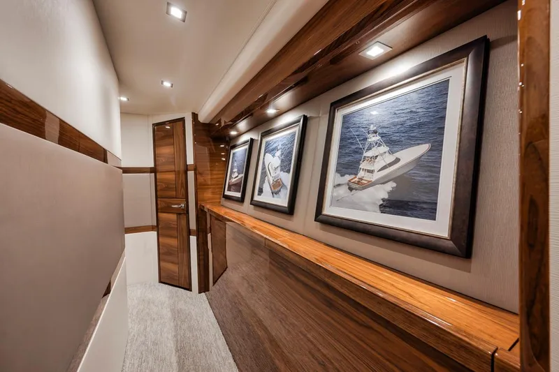 Slide: The Image of Interior hallway of 2023 Viking 72 Convertible yacht with framed boat artwork. - 38