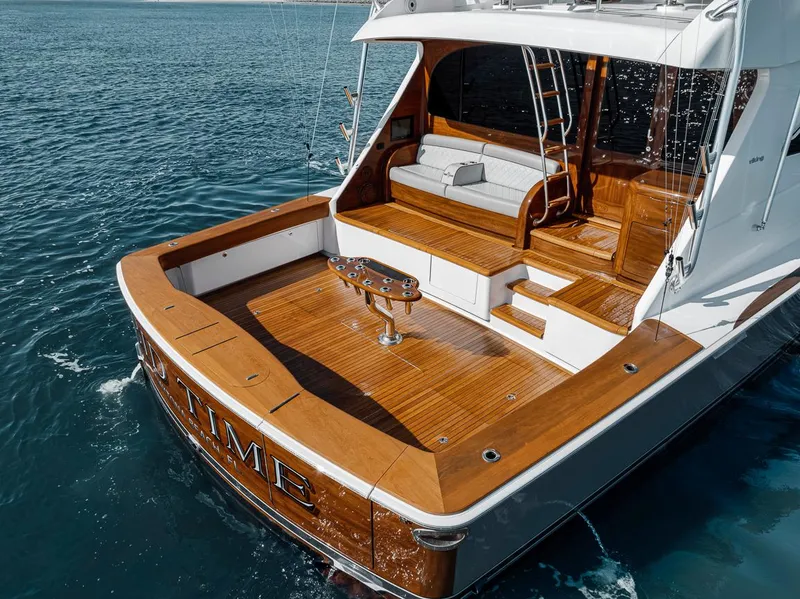 Slide: The Image of 2023 Viking 72 Convertible yacht with wooden deck on calm ocean waters. - 4