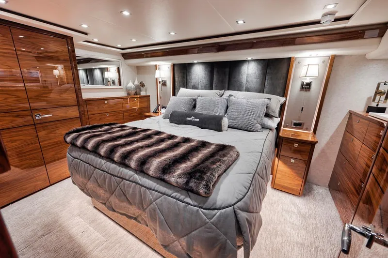 Slide: The Image of Luxurious bedroom interior of 2023 Viking 72 Convertible yacht with elegant wood finishes. - 40