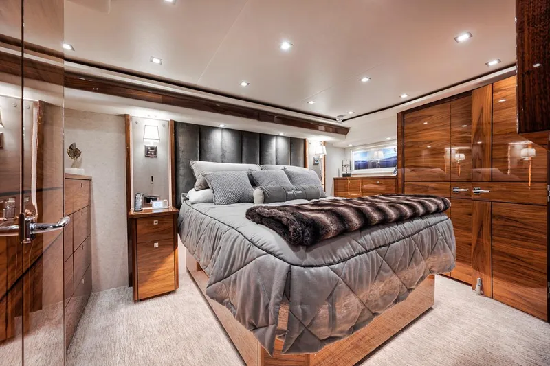 Slide: The Image of Luxurious bedroom interior of 2023 Viking 72 Convertible yacht, featuring elegant wood finishes. - 41