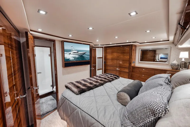 Slide: The Image of Luxurious bedroom interior of 2023 Viking 72 Convertible yacht with modern decor and wood finishes. - 42