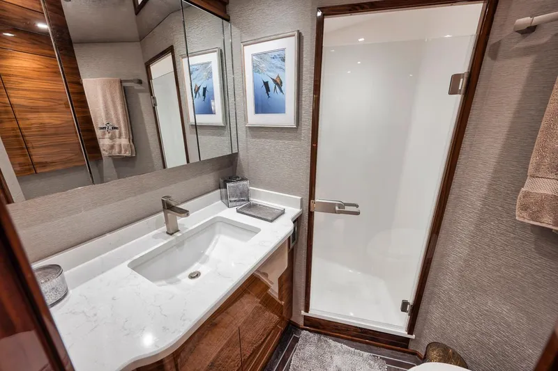 Slide: The Image of Luxurious bathroom in 2023 Viking 72 Convertible yacht with modern fixtures and elegant design. - 43