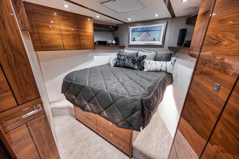 Slide: The Image of Luxurious bedroom interior of 2023 Viking 72 Convertible yacht with wood finishes and modern decor. - 44
