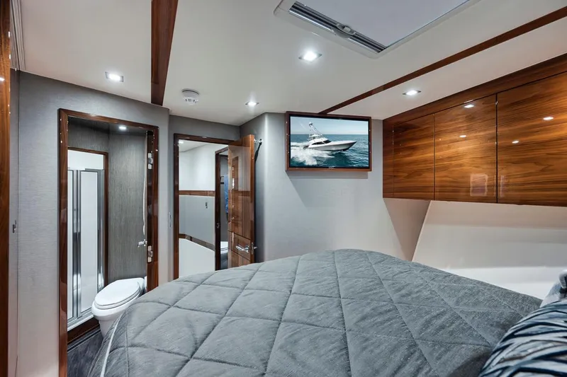 Slide: The Image of Luxurious bedroom interior of 2023 Viking 72 Convertible yacht with ensuite bathroom. - 45