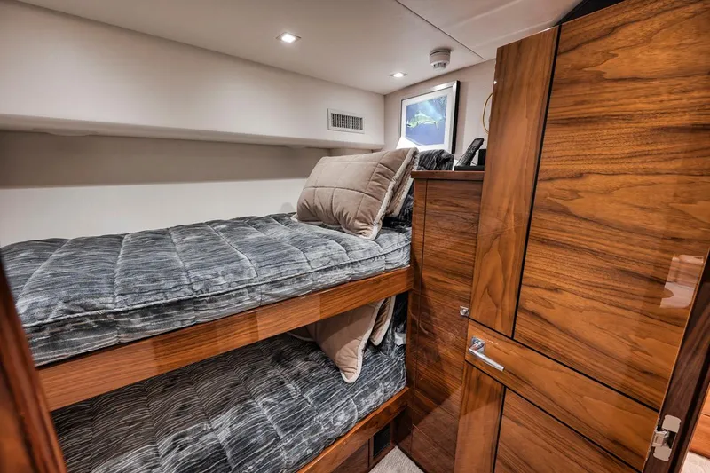 Slide: The Image of 2023 Viking 72 Convertible yacht interior with wooden bunk beds and modern design. - 48