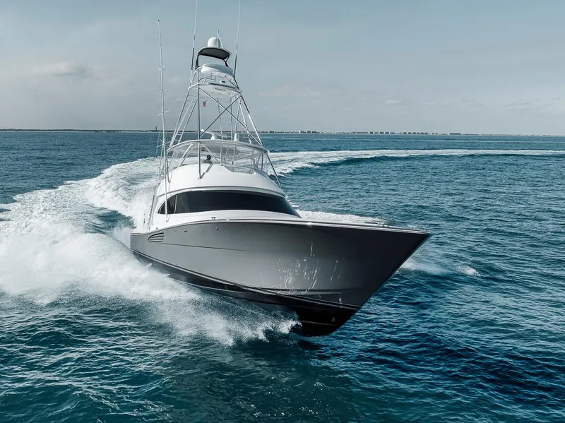Slide: The Image of 2023 Viking 72 Convertible yacht cruising on open water. - 5
