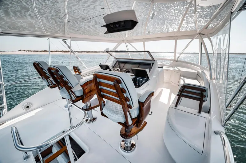 Slide: The Image of 2023 Viking 72 Convertible yacht interior with luxurious seating and ocean view. - 68