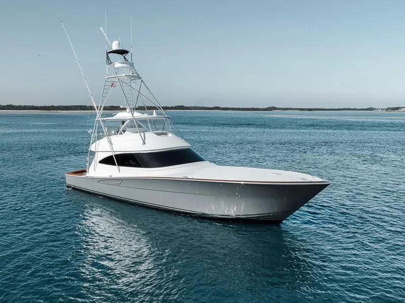 Slide: The Image of 2023 Viking 72 Convertible yacht on calm blue waters. - 7