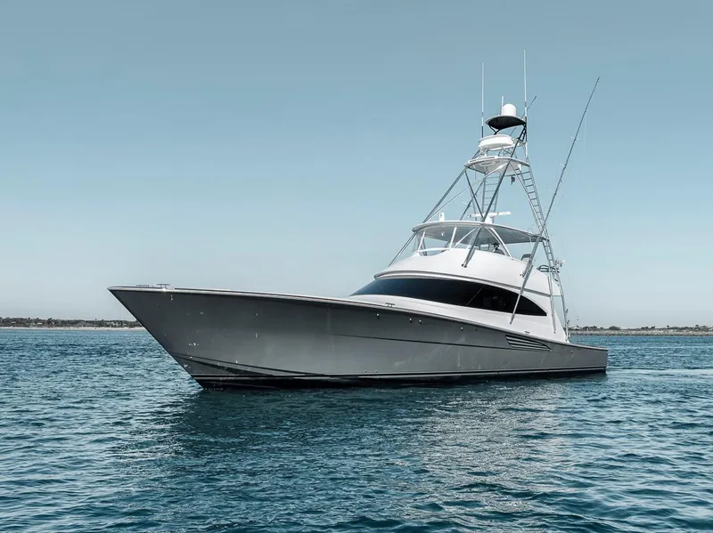 Slide: The Image of 2023 Viking 72 Convertible yacht on calm blue water. - 9