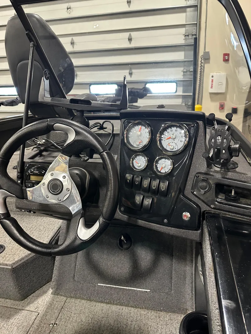 Slide: The Image of 2023 Tracker Targa V-18 WT boat dashboard with steering wheel and gauges. - 9