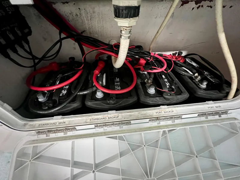 Slide: The Image of Battery compartment of a 2006 Twin Vee 26 Express boat with labeled connections. - 15