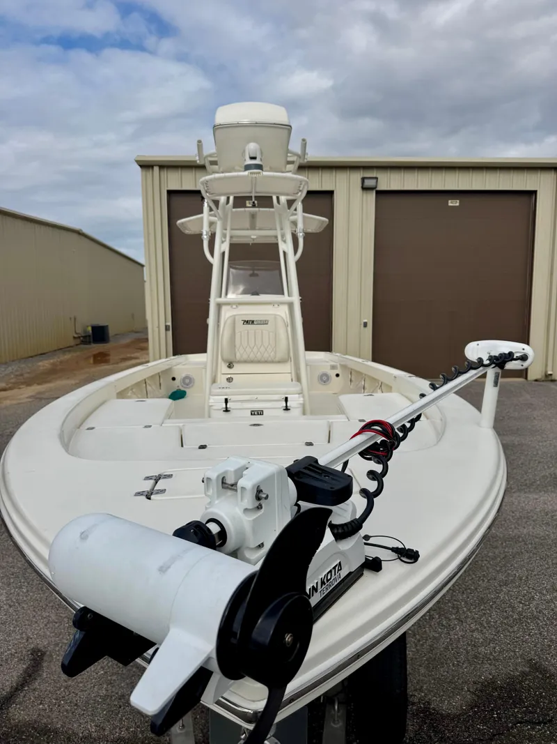 Slide: The Image of 2019 Pathfinder 2600 HPS boat with trolling motor, parked near storage facility. - 17