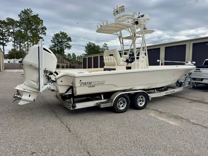 Slide: The Image of 2019 Pathfinder 2600 HPS boat on trailer, parked outdoors near storage units. - 3