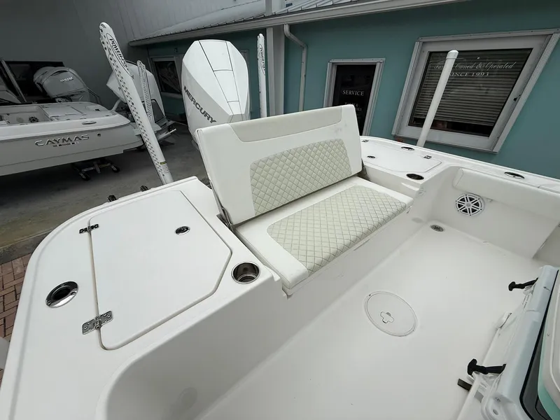 Slide: The Image of 2021 Caymas 26 HB boat interior with cushioned seating and storage compartments. - 12