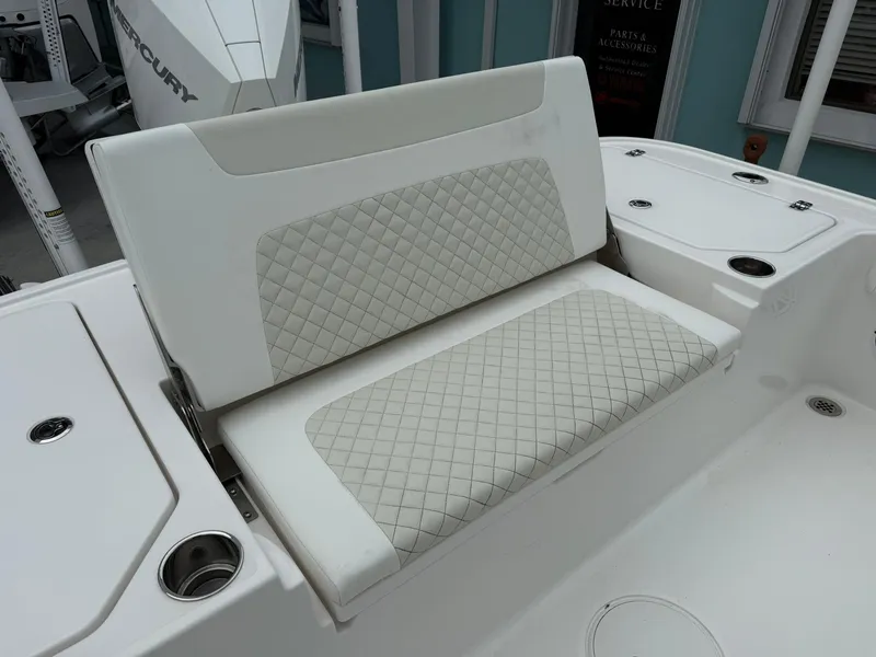 Slide: The Image of 2021 Caymas 26 HB boat with white quilted seating and cup holders. - 13