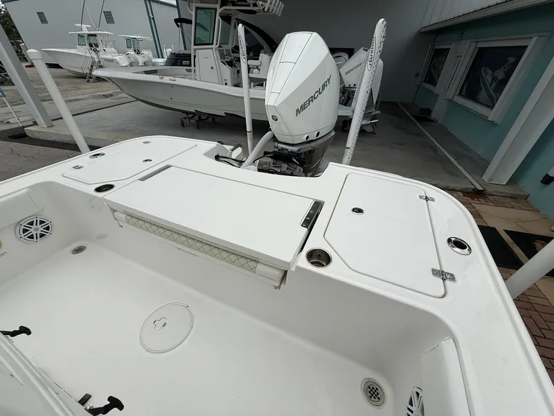 Slide: The Image of 2021 Caymas 26 HB boat with Mercury engine, white deck, and fishing features. - 14