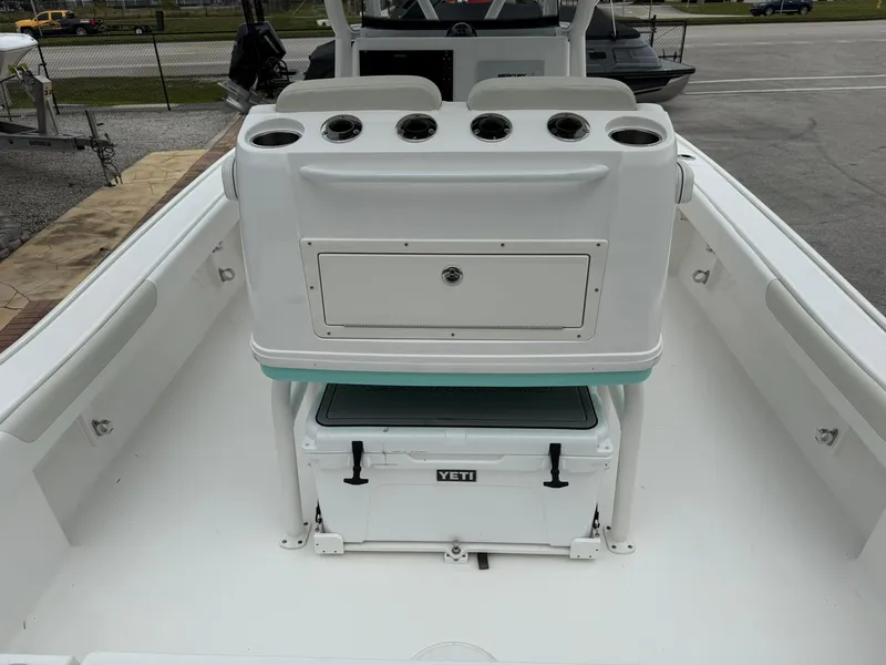 Slide: The Image of 2021 Caymas 26 HB boat interior with Yeti cooler and storage compartment. - 17