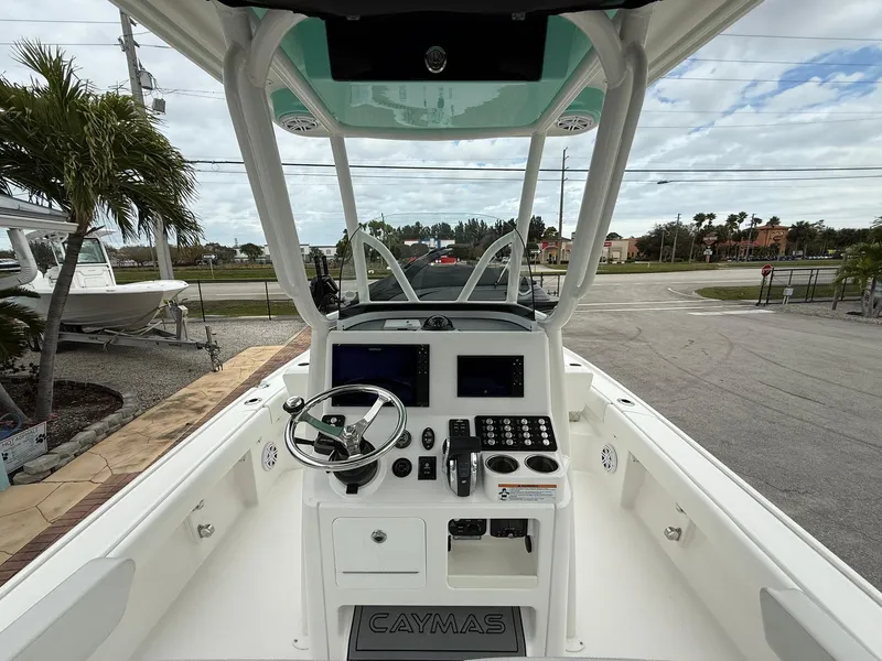 Slide: The Image of 2021 Caymas 26 HB boat cockpit with steering wheel and control panel. - 18