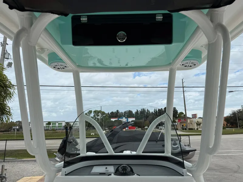 Slide: The Image of 2021 Caymas 26 HB boat interior with windshield and overhead console. - 19
