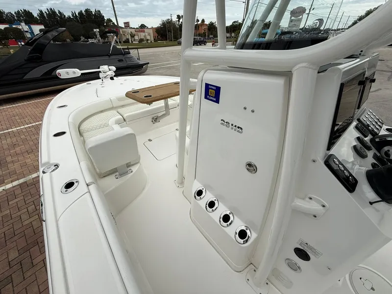 Slide: The Image of 2021 Caymas 26 HB boat interior with console and seating area. - 27