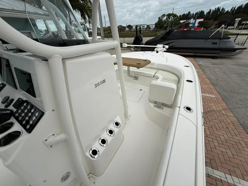 Slide: The Image of 2021 Caymas 26 HB boat interior with control panel and seating area. - 28