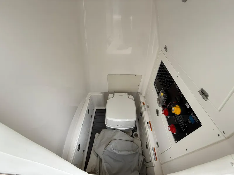 Slide: The Image of 2021 Caymas 26 HB boat interior with compact toilet and control panel. - 40