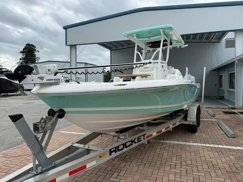 Slide: The Image of 2021 Caymas 26 HB boat on trailer, parked outside a building. - 5
