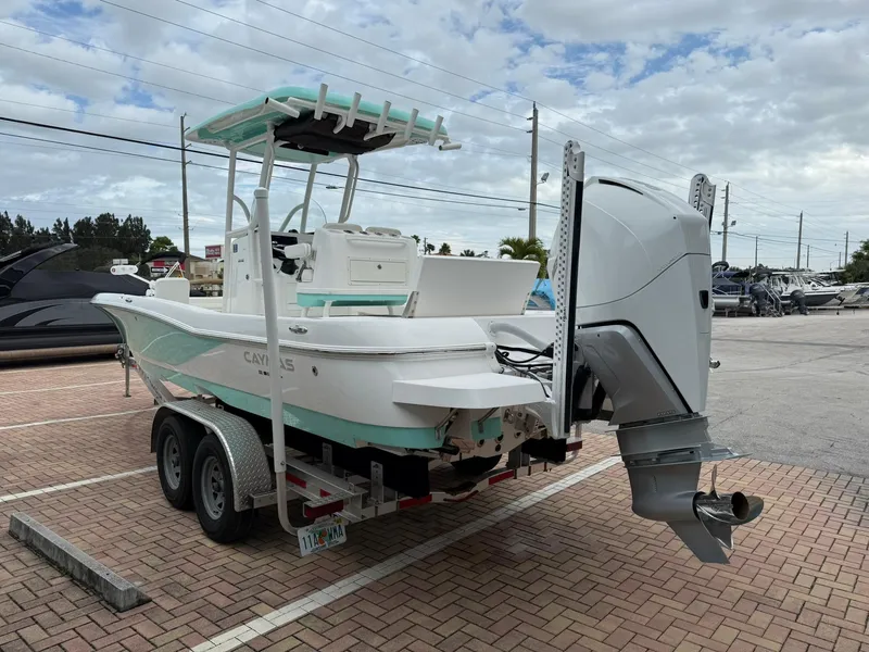 Slide: The Image of 2021 Caymas 26 HB boat on trailer, parked outdoors under cloudy sky. - 7