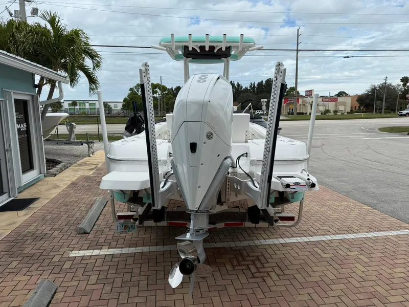Slide: The Image of 2021 Caymas 26 HB boat, rear view, parked on brick pavement near a building. - 8