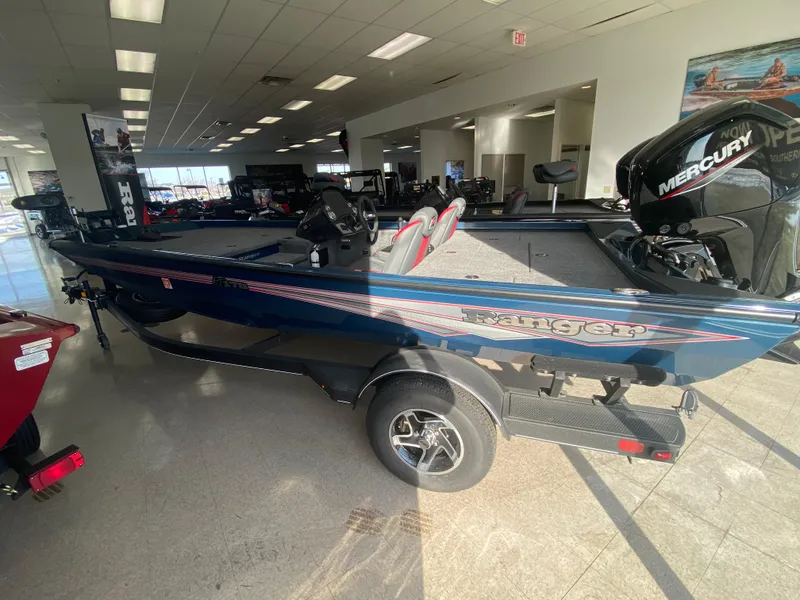 Slide: The Image of 2024 Ranger RT178 boat in showroom, featuring sleek design and Mercury engine. - 0