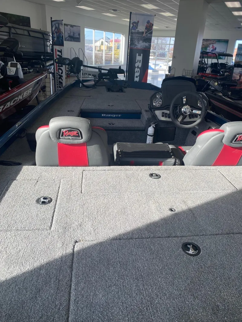 Slide: The Image of 2024 Ranger RT178 boat interior with seating and steering console in showroom. - 1