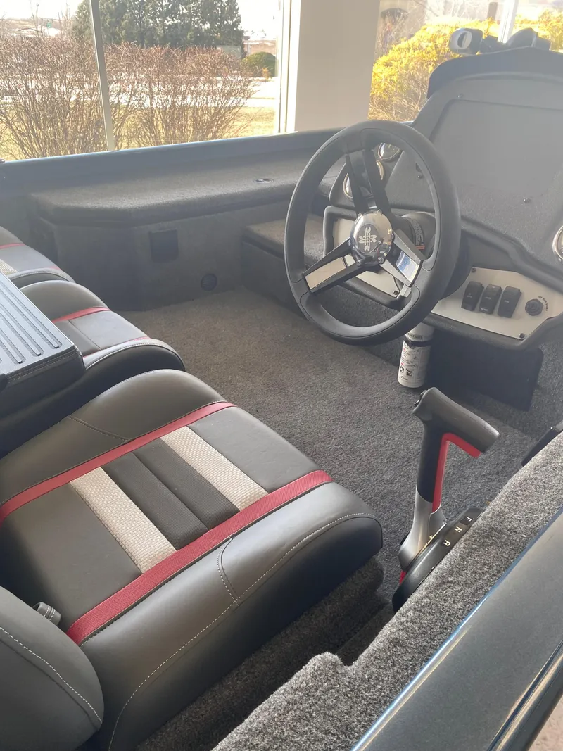 Slide: The Image of 2024 Ranger RT178 boat interior with steering wheel and seating. - 2