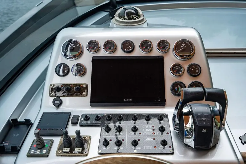 Slide: The Image of Control panel of a 2015 CNM 43 Continental yacht with gauges and navigation equipment. - 12