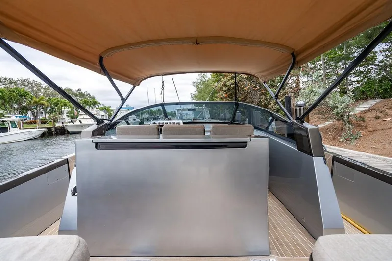 Slide: The Image of 2015 CNM 43 Continental yacht with canopy, docked in a serene marina setting. - 15