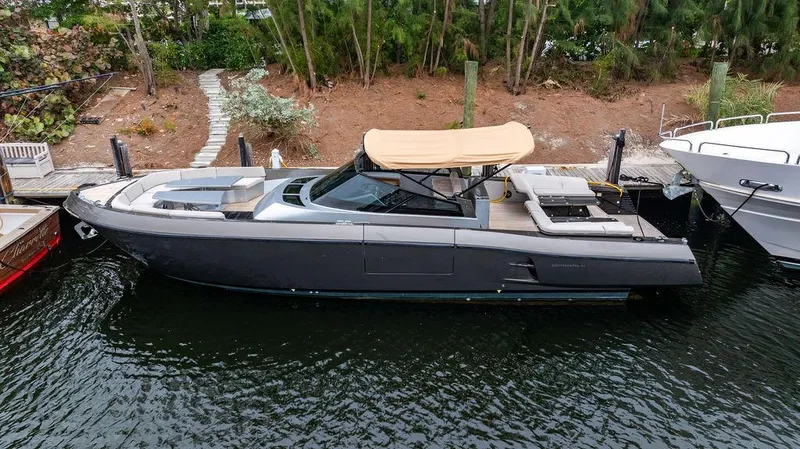 Slide: The Image of 2015 CNM 43 Continental yacht docked, featuring sleek design and beige canopy. - 2