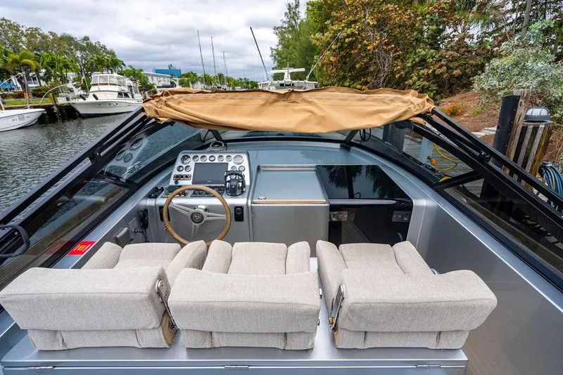Slide: The Image of 2015 CNM 43 Continental boat interior with beige seats and control panel. - 8