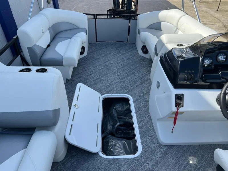 Slide: The Image of 2025 JC 201 Spirit TT Sport boat interior with open storage compartment and plush seating. - 4