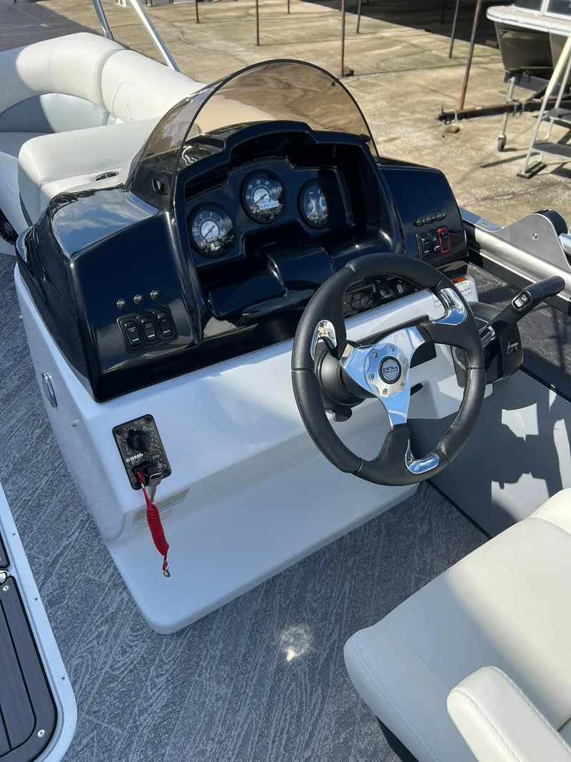 Slide: The Image of 2025 JC 201 Spirit TT Sport boat dashboard with steering wheel and gauges. - 5